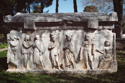 image: An ancient stone sculpture with carved figures.